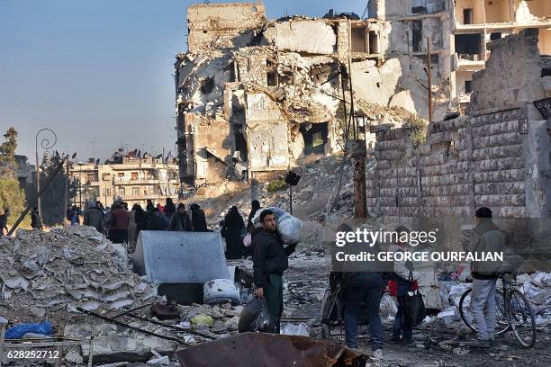 Syrian residents fleeing the violence in the eastern rebel-held parts of Aleppo evacuate from their neighbourhoods through the Bab al-Hadid district...