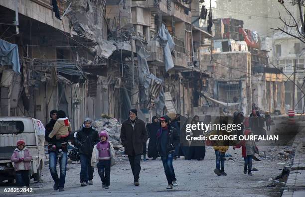 Syrian residents fleeing the violence in the eastern rebel-held parts of Aleppo evacuate from their neighbourhoods through the Bab al-Hadid district...