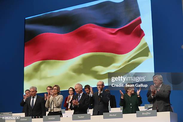 German Chancellor and Chairwoman of the German Christian Democrats Angela Merkel and leading members of her party applaude after singing the German...