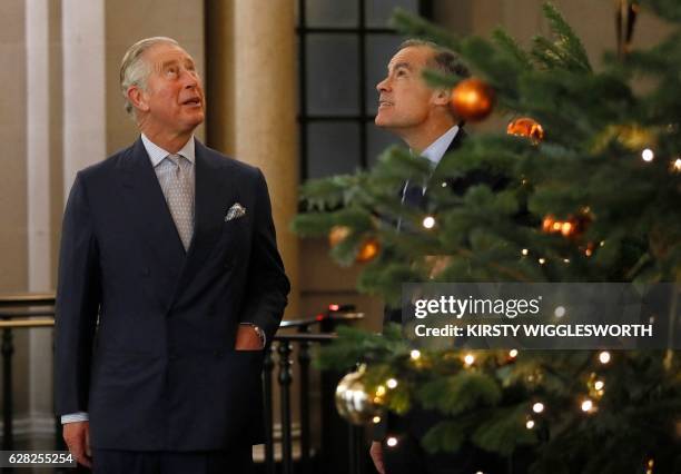 Britain's Prince Charles, Prince of Wales admires a Christmas tree as Bank of England Governor Mark Carney shows him around the Bank of England in...