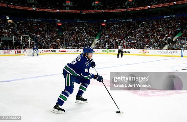 Philip Larsen of the Vancouver Canucks skates up ice with the puck during their NHL game against the Toronto Maple Leafs at Rogers Arena December 3,...