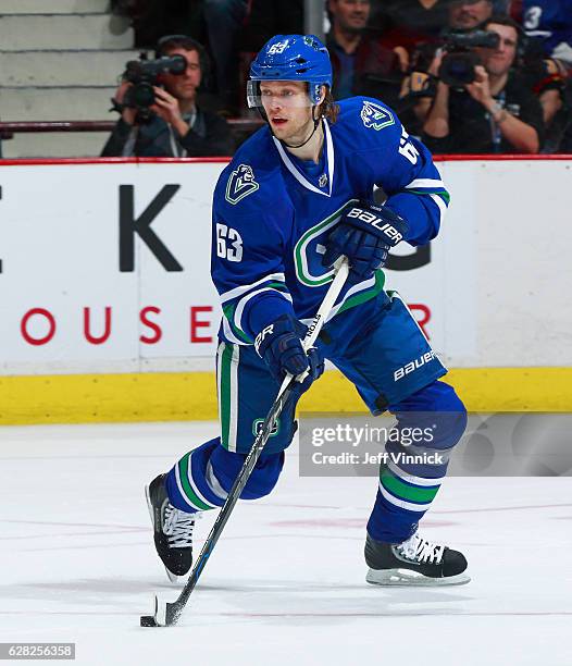 Philip Larsen of the Vancouver Canucks skates up ice with the puck during their NHL game against the Toronto Maple Leafs at Rogers Arena December 3,...
