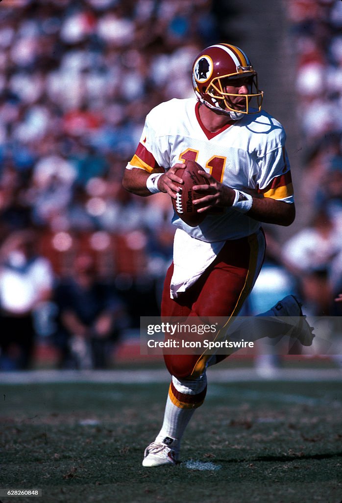 1980's: Quarterback Mark Rypien of the Washington Redskins rolls out ...