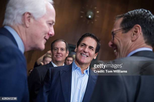 Mark Cuban, center, Chairman of AXS TV, talks with Senate Majority Whip John Cornyn, R-Texas, left, and Randall Stephenson, right, CEO of AT&T,...