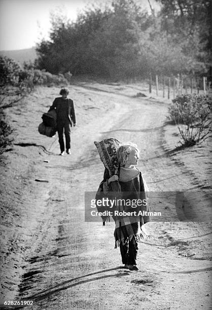 Young child walks on Coleman Valley Road heading towards Wheelers Ranch on March 25, 1970 in Occidental, California.