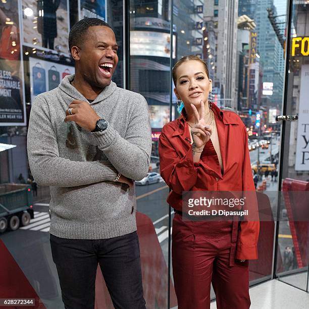 Calloway interviews Rita Ora during her visit to "Extra" at their New York studios at H&M in Times Square on December 7, 2016 in New York City.