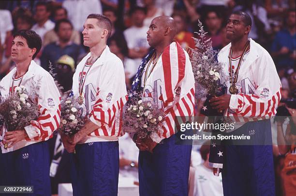 John Stockton, Chris Mullen, Charles Barkley and Magic Johnson of the USA during the medal cermony after winning gold medal in men's basketball at...