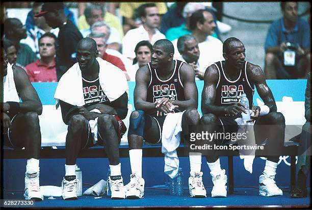 Michael Jordan , Magic Johnson and Clyde Drexler of Team USA, the Dream Team, sit on the bench during the men's basketball competition at the 1992...
