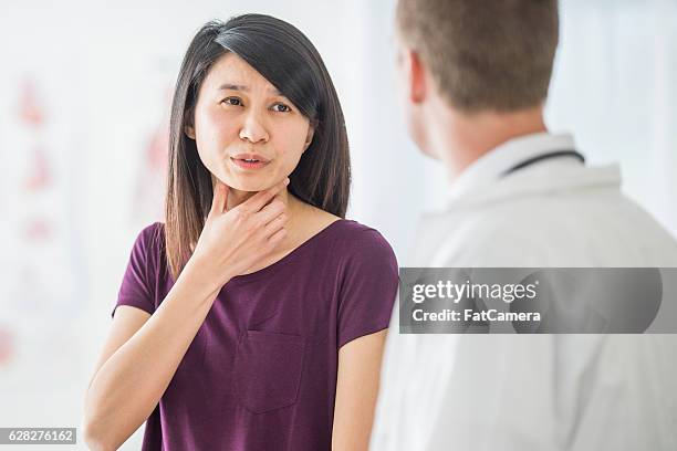 getting advice on a cold - throat exam stock pictures, royalty-free photos & images