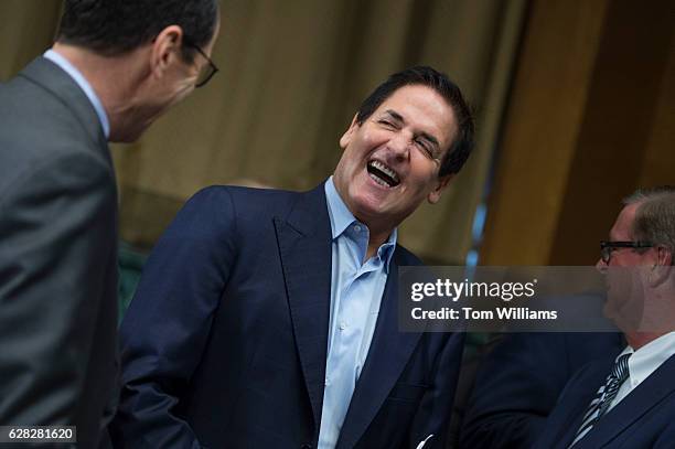 Mark Cuban, center, Chairman of AXS TV, talks with Randall Stephenson, left, CEO of AT&T, before a Senate Judiciary Subcommittee on Antitrust,...