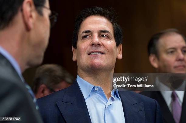 Mark Cuban, center, Chairman of AXS TV, talks with Randall Stephenson, left, CEO of AT&T, before a Senate Judiciary Subcommittee on Antitrust,...