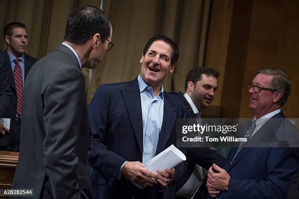 Mark Cuban, center, Chairman of AXS TV, talks with Randall Stephenson, left, CEO of AT&T, before a Senate Judiciary Subcommittee on Antitrust,...