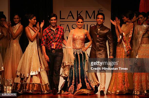 Designer Manish Malhotra, Bollywood Actor Tushar Kapoor and Actress Genelia D'souza walks on the ramp in a Manish Malhotra creation at Lakme Fashion...