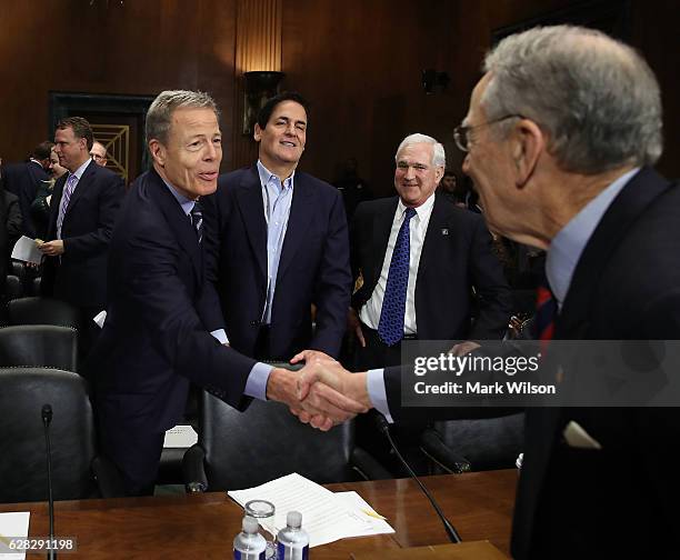 Sen. Chuck Grassley greets Jeffrey Bewkes, CEO of Time Warner; Mark Cuban, chairman of AXS TV and owner of the Dallas Mavericks; and Gene Kimmelan,...