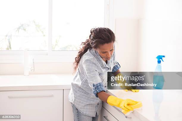 woman cleaning the kitchen. - black glove stock pictures, royalty-free photos & images