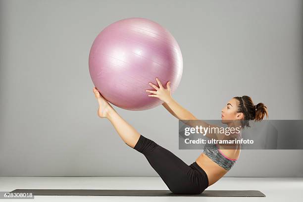 pilates stretching training woman practicing on a fitness ball - pilates bildbanksfoton och bilder