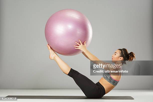 pilates stretching  training   woman practicing on a fitness ball - pilates 個照片及圖片檔