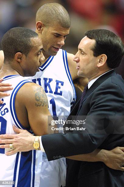 Shane Battier, Jason Williams and head coach Mike Krzyzewski of Duke all share a hug after defeating Maryland 95-84 during the semifinal of the Men's...