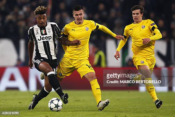 Juventus' defender Mario Lemina from France fights for the ball with Dinamo's forward Amer Gojak of Bosnia Erzegovina during the UEFA Champions...