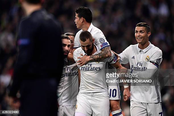 Real Madrid's French forward Karim Benzema celebrates a goal with teammates Real Madrid's Colombian midfielder James Rodriguez and Real Madrid's...