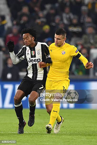 Juan Cuadrado of Juventus clashes with Amer Gojak of GNK Dinamo Zagreb during the UEFA Champions League Group H match between Juventus and GNK Dinamo...