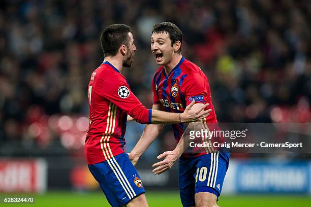 Moscow's Alan Dzagoev celebrates scoring the opening goal with team mate CSKA Moscow's Zoran Tosic during the UEFA Champions League match between...