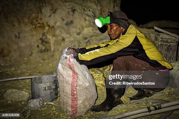 filling a sulphur sack, at ijen crater - headlamp miner stock pictures, royalty-free photos & images