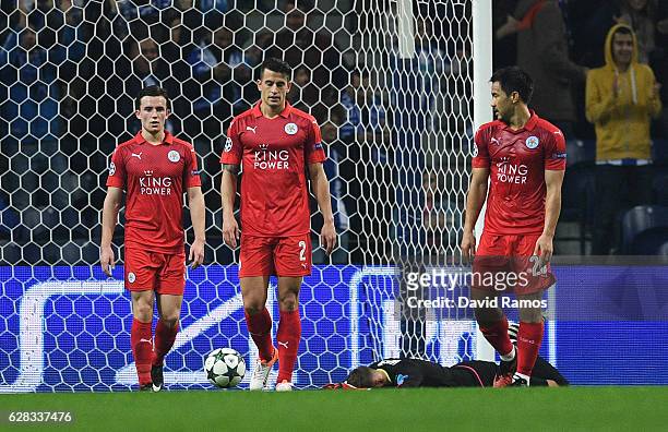 Ben Chilwell of Leicester City , Luis Hernandez of Leicester City and Shinji Okazaki of Leicester City are dejected after FC Porto score their third...