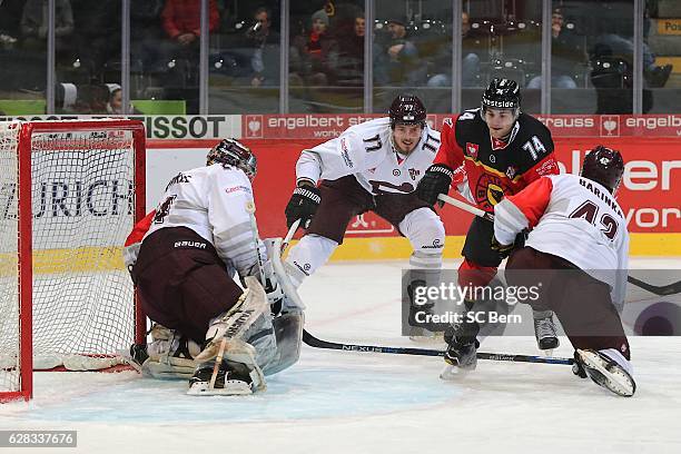 Marco Mueller of Bern challenges goalkeeper Tomas Popperle of Prague during the Champions Hockey League Quarter Final match between SC Bern and...