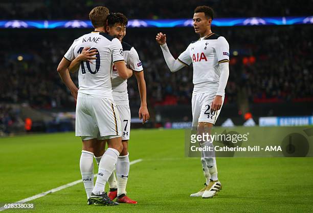 Son Heung-min and Dele Alli of Tottenham Hotspur congratulate Harry Kane of Tottenham Hotspur after he scores to make it 2-1 during the UEFA...