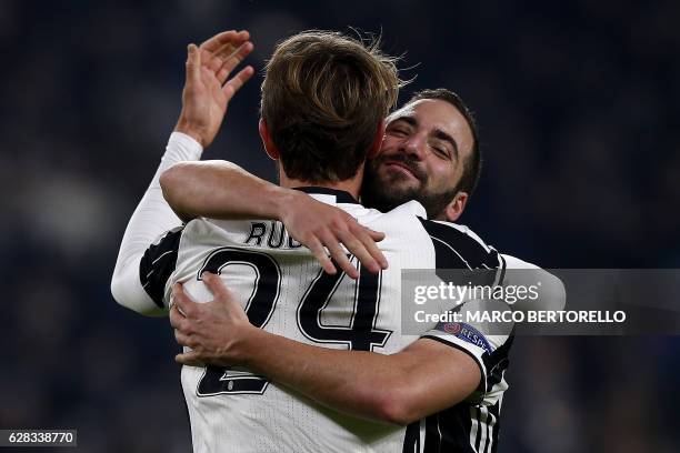 Juventus' defender Daniele Rugani celebrates after scoring with Juventus' forward Gonzalo Higuain from Argentina during the UEFA Champions League...