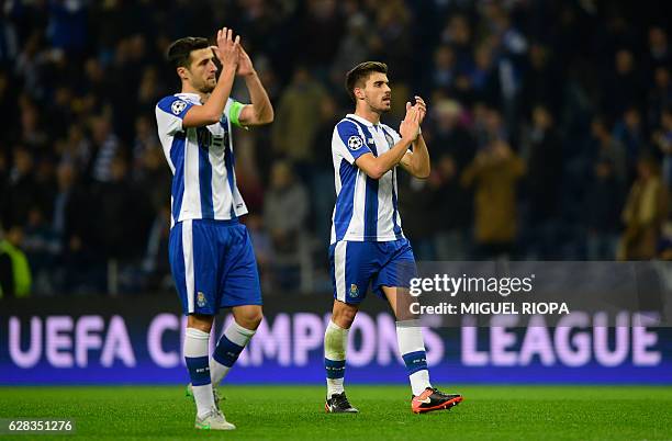 Porto's Spanish defender Ivan Marcano and midfielder Ruben Neves applaud to supporters at the end of the UEFA Champions League football match FC...