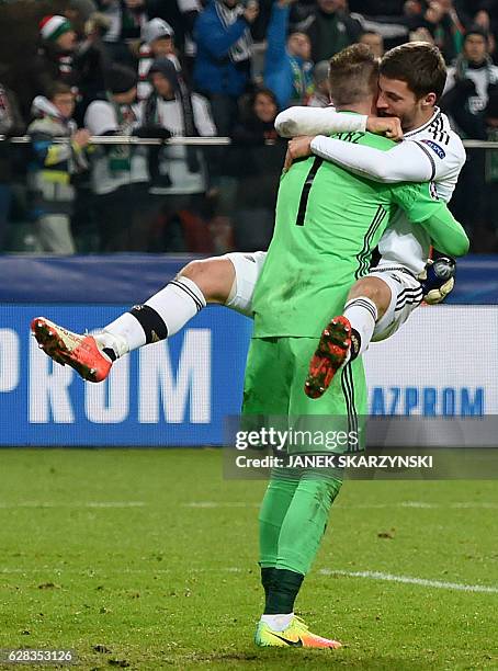 Legia Warsaw's Bartosz Bereszynski and his teammate goalkeeper Arkadiusz Malarz celebrate after Legia won the UEFA Champions League group F match...