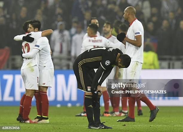 Lyon's French midfielder Maxime Gonalons reacts as Sevilla's players celebrate at the end of the UEFA Champions League Group H football match between...