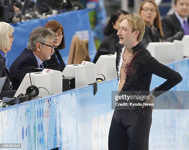 Russia - Evgeni Plushenko of Russia informs a judge of his withdrawal from the men's short program figure skating competition at the Iceberg Skating...