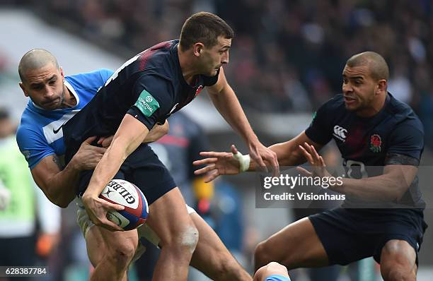 Jonny May of England is held up by Juan Pablo Estelles of Argentina but offloads to Jonathan Joseph during the Old Mutual Wealth Series autumn...