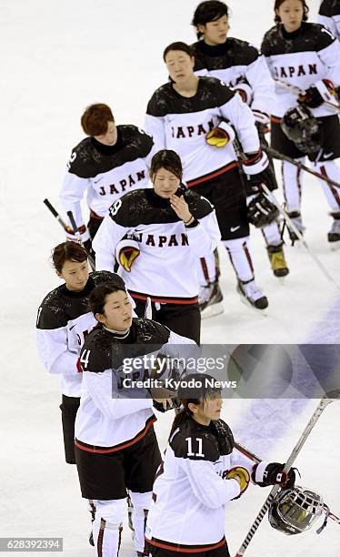 Russia - Japanese players leave the ice after losing 4-0 to Germany in a Group B preliminary-round game in the women's ice hockey at the Sochi...