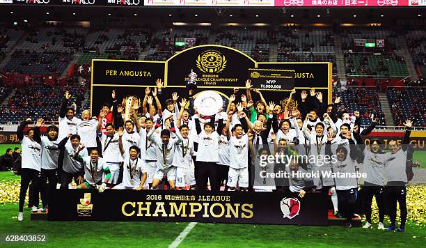 Players of Kashima Antlers celebrate with the Schale after during the J.League Championship Final second leg match between Urawa Red Diamonds and...