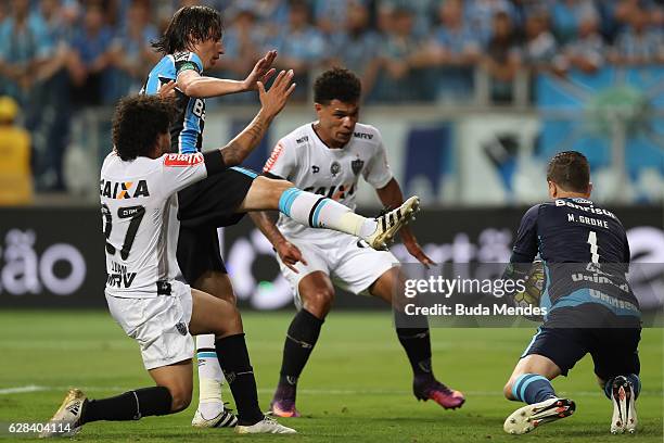 Goalkeeper Marcelo Grohe of Gremio struggles for the ball with Luan of Atletico MG during a match between Gremio and Atletico MG as part of Copa do...