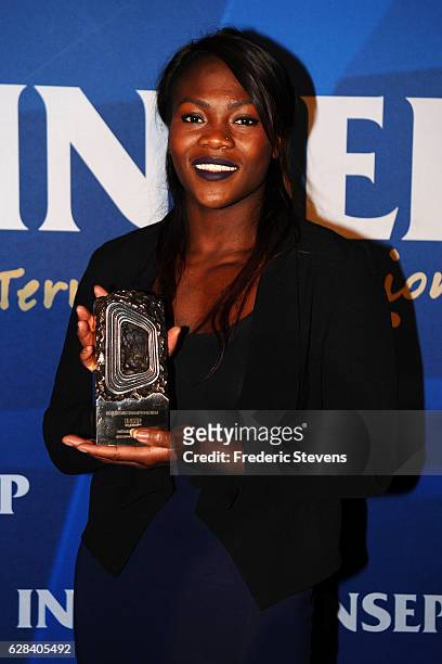 Olympic medalist judoka Clarisse Agbegnenou poses whit her trophy at the 9th annual Champions Soiree held at INSEP on December 7, 2016 in Paris,...