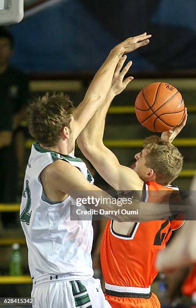 Henry Caruso of the Princeton Tigers tries to shoot over Jack Purchase of the Hawaii Rainbow Warriors during the first half of the Pearl Harbor...