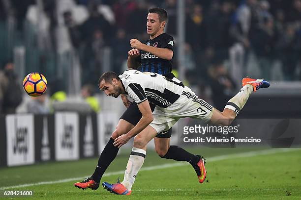 Giorgio Chiellini of Juventus FC is tackled by Aleksandar Pesic of Atalanta BC during the Serie A match between Juventus FC and Atalanta BC at...