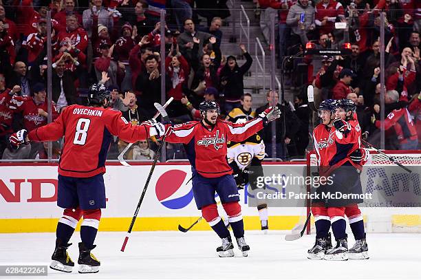 Nicklas Backstrom of the Washington Capitals celebrates with his teammates after scoring the game-winning goal in overtime during a NHL game against...