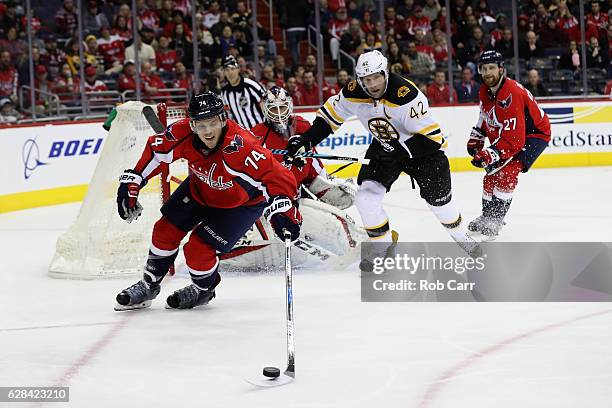 John Carlson of the Washington Capitals goes after the puck in front of David Backes of the Boston Bruins at Verizon Center on December 7, 2016 in...