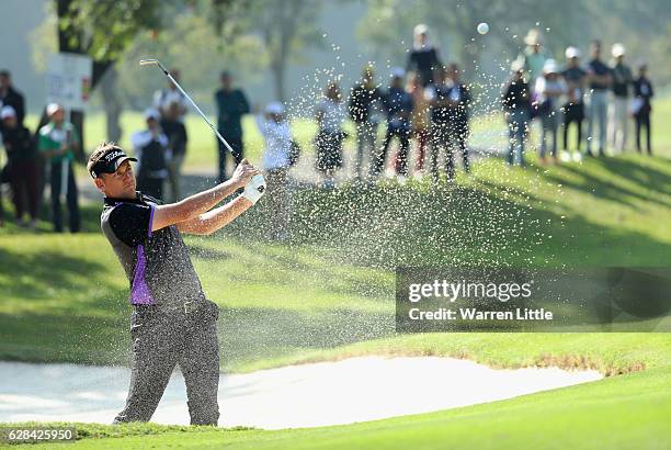 Ian Poulter of England plays out of the third greenside bunker during the first round of the UBS Hong Kong Open at The Hong Kong Golf Club on...