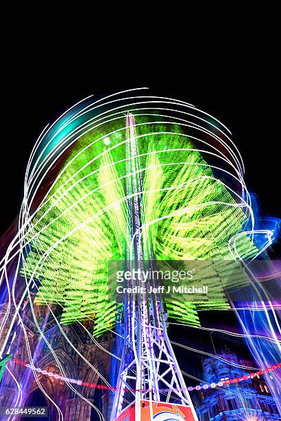 Members of the public enjoy a ride on the Star Flyer on December 7, 2016 in Edinburgh, Scotland. The Christmas Market is situated in Princes Street...
