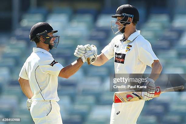 Jonathan Wells and Adam Voges of Western Australia celebrate after hitting the winning runs during day four of the Sheffield Shield match between...