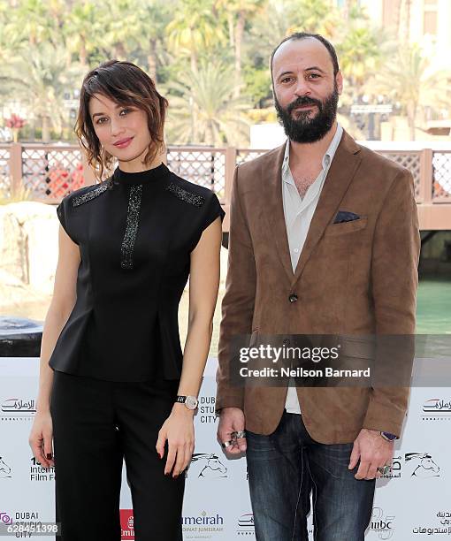 Olga Kurylenko and Ali Suliman attend the IWC Filmmaker Award photocall during day two of the 13th annual Dubai International Film Festival held at...