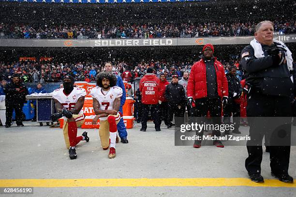 Eli Harold and Colin Kaepernick of the San Francisco 49ers kneel on the sideline, during the anthem, prior to the game against the Chicago Bears at...
