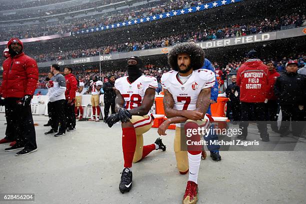 Eli Harold and Colin Kaepernick of the San Francisco 49ers kneel on the sideline, during the anthem, prior to the game against the Chicago Bears at...